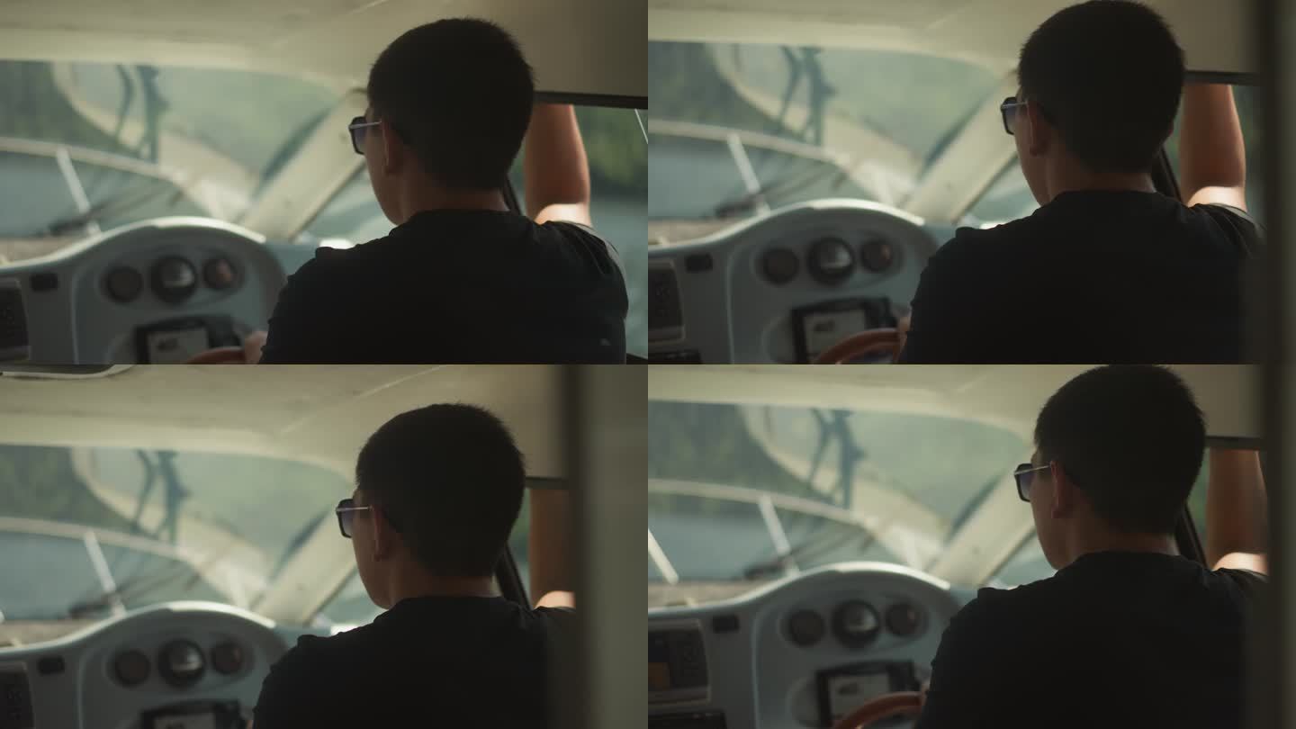 自信的船长戴着墨镜在驾驶舱驾驶游艇