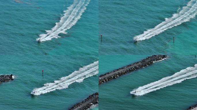 小摩托艇在波涛起伏的海面上疾驰。帆船在佛罗里达的海洋上运动