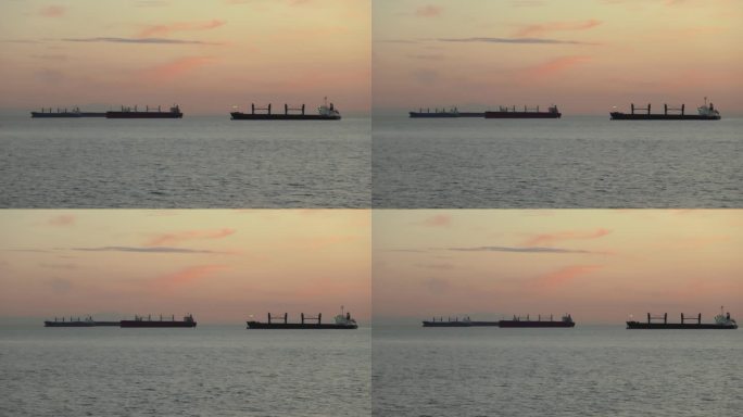 三艘大型军舰在日落时分航行