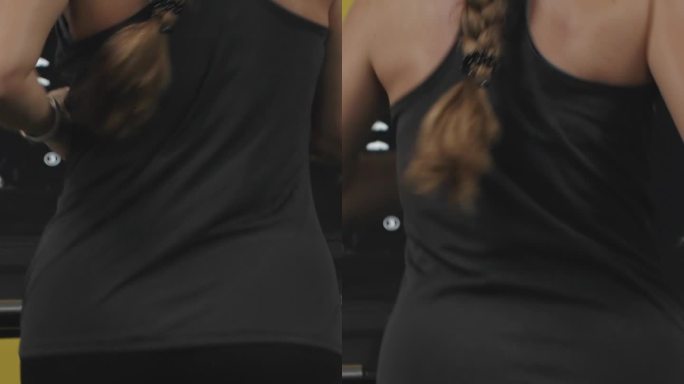垂直视频。长头发的年轻女子在跑步机上。她背上的汗珠。有效减肥。