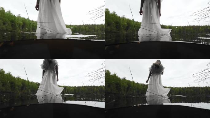 身穿白色透明透明长裙的女子站在水中。