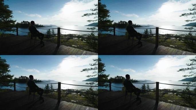 独自一人坐在阳台上，欣赏美丽的风景与湖，黑暗的剪影