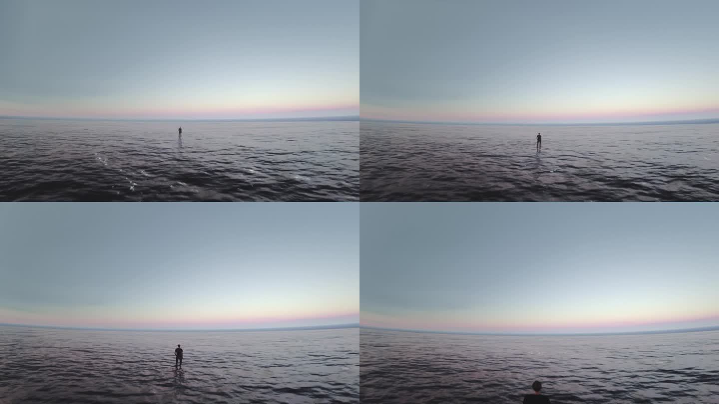 无人机拍摄的视频显示一名单身男子站在海中央望着地平线。世界末日。冥想，透视，孤独，独自面对困难的概念
