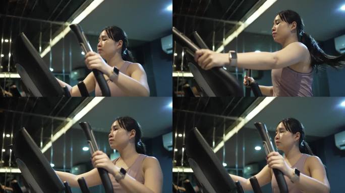 女性在健身房里的椭圆机上锻炼左臂的剪影。