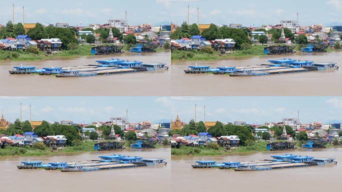 放大三艘载满沙子的采砂驳船，停泊在金边的湄公河沿岸。