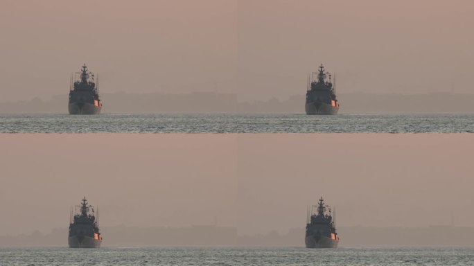 日落时分，一艘军舰在河上航行