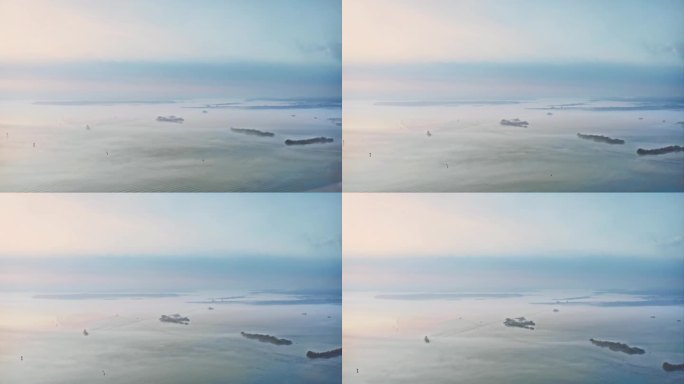 雾笼罩着水面。薄雾笼罩的岛屿，过往的船只。无人机航拍