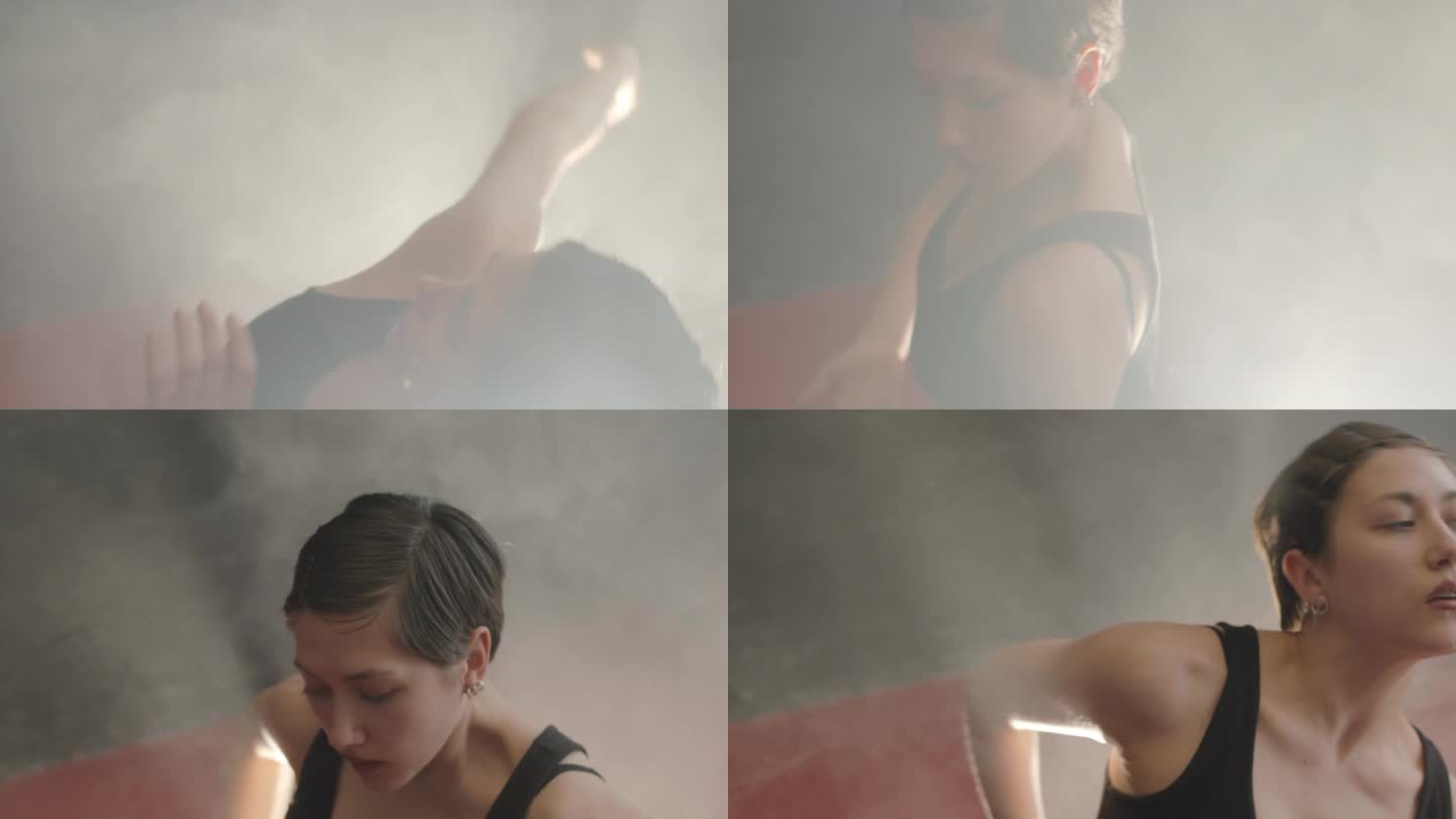 在烟雾中表演当代舞蹈的女舞者
