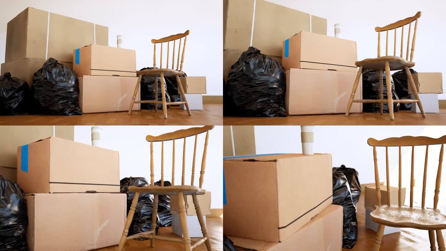 移动主题:空房间与椅子和纸箱，纸箱上的纸杯