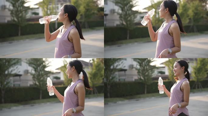 年轻的健身女性在户外公园里一边喝能量水一边做伸展运动。晚上锻炼身体，健康观念慢无影