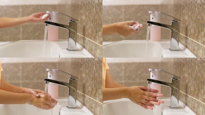 小男孩在浴室里用泡沫肥皂洗手。日常卫生习惯。健康的习惯