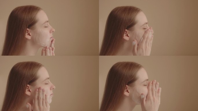 年轻女子用洁面泡沫洗脸。日常美容程序。慢动作