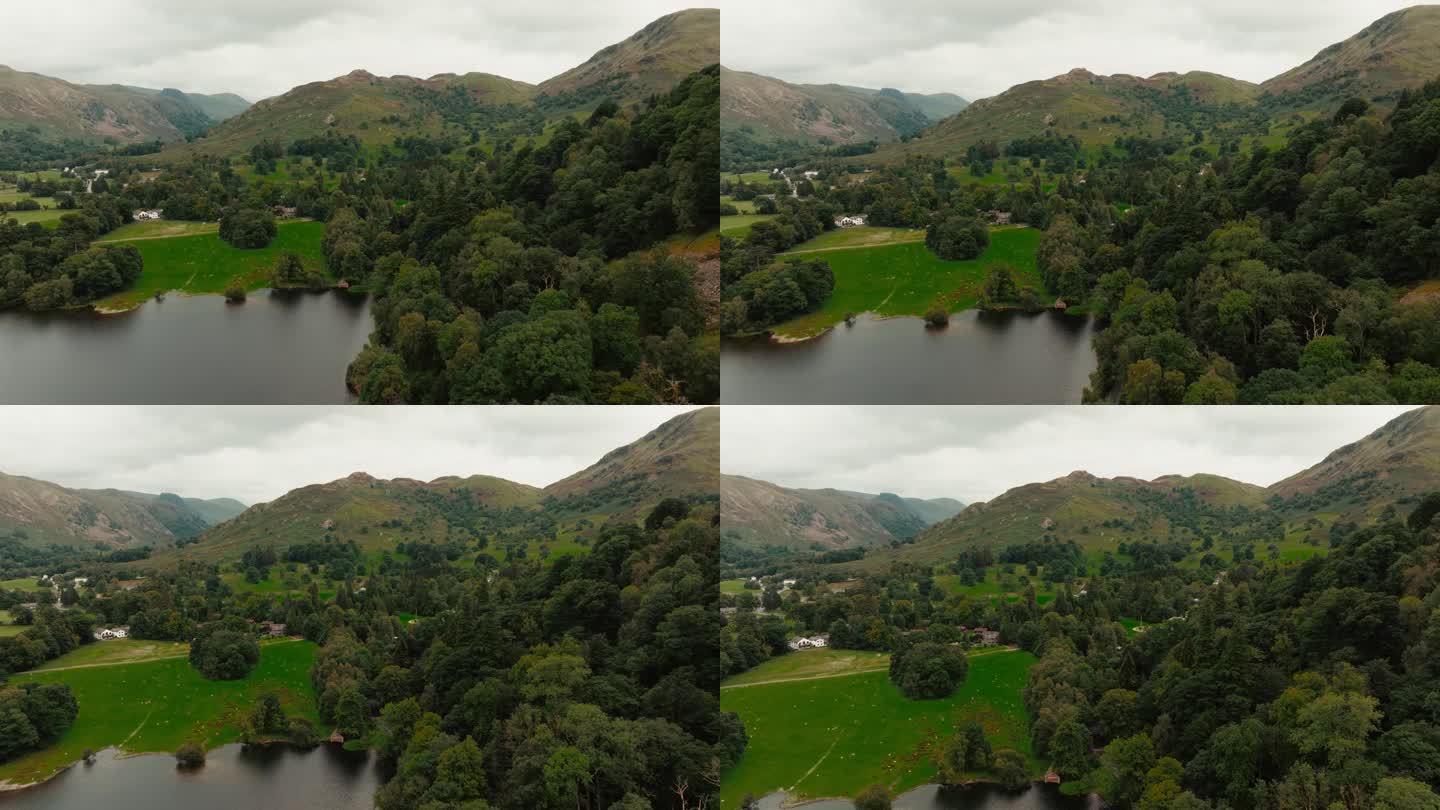无人机飞向美丽的绿色山脉和草地景观，位于英国著名的湖区。