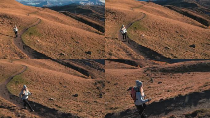 成熟的女性徒步旅行者探索高山山坡，秋天