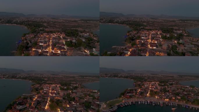 土耳其，边老城照亮沿海住宅鸟瞰图在日落时飞过建筑物屋顶