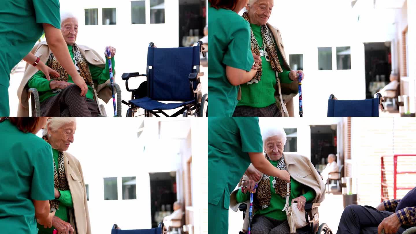 护士长在护理院花园协助长者坐在轮椅上，4K录影带。