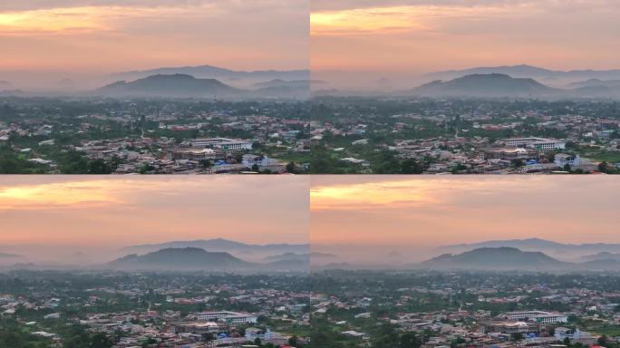 空中无人机日出场景与美丽的天空和雾在雅拉市，泰国南部，雅拉省