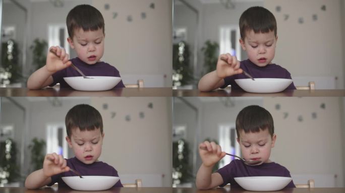 伤心失意的男小孩男小孩在家里吃着白盘子厨房里的食物