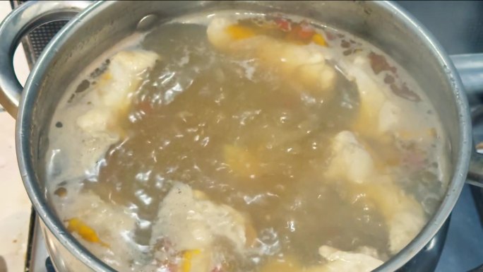 厨房炉子上的金属锅正在煮汤。