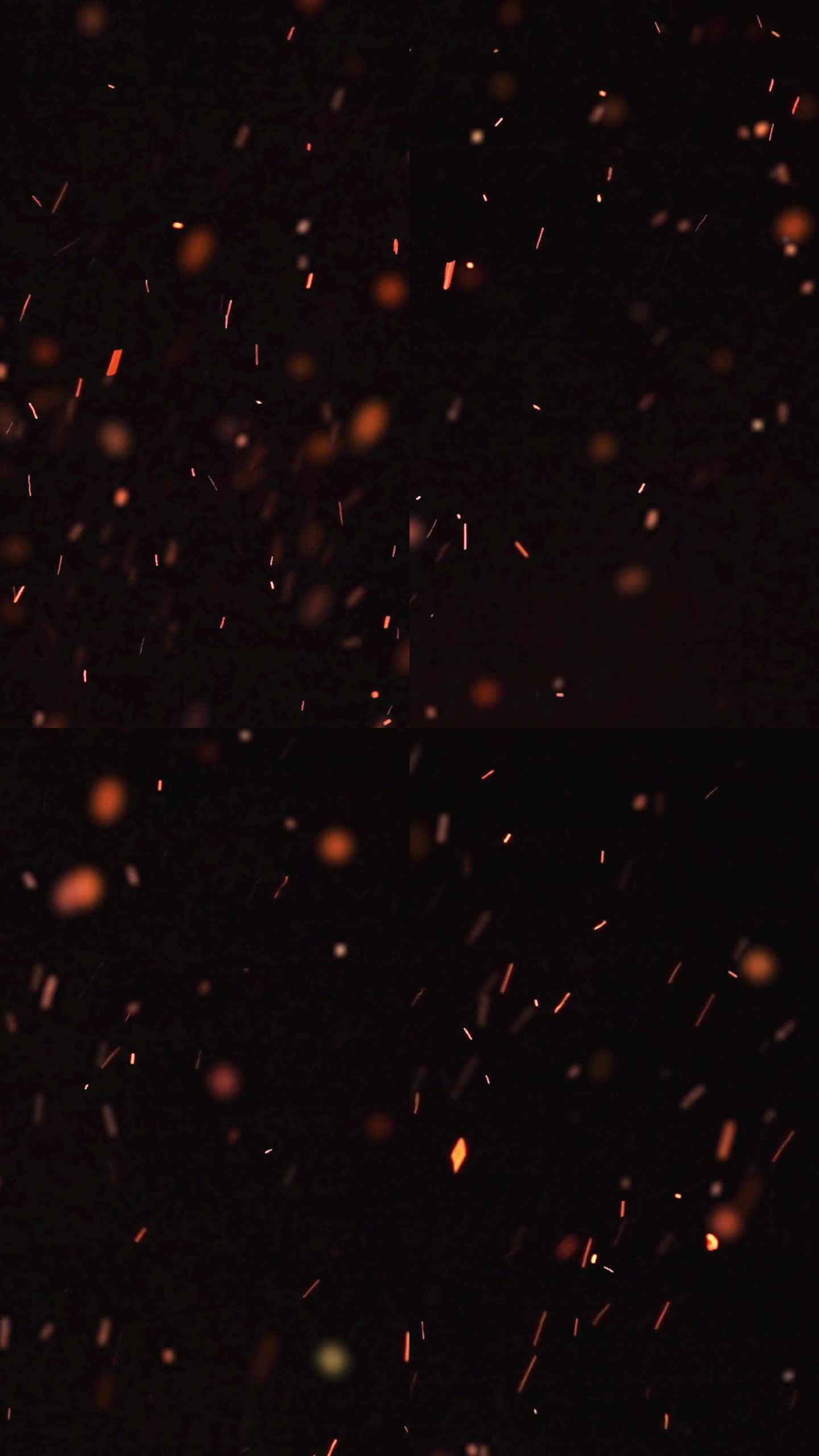 超慢动作的火焰和发光的灰烬颗粒在黑色背景高速拍摄-垂直视频卷轴和故事
