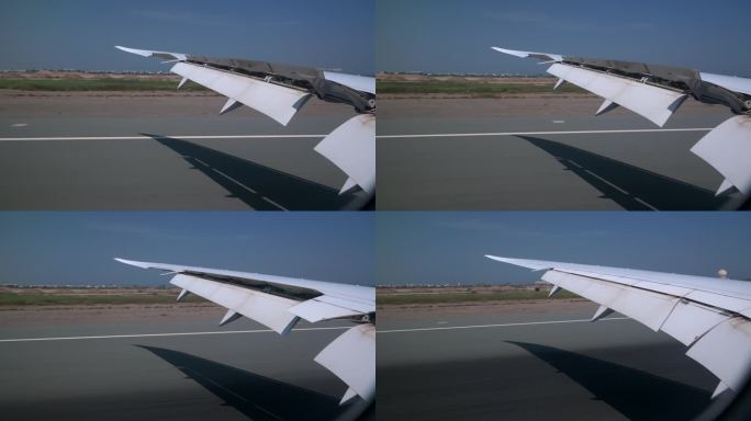 在机场着陆时，从窗户看飞机机翼侧面