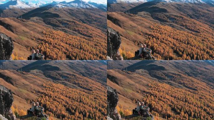 成熟的登山夫妇在高山山坡上放松，秋天