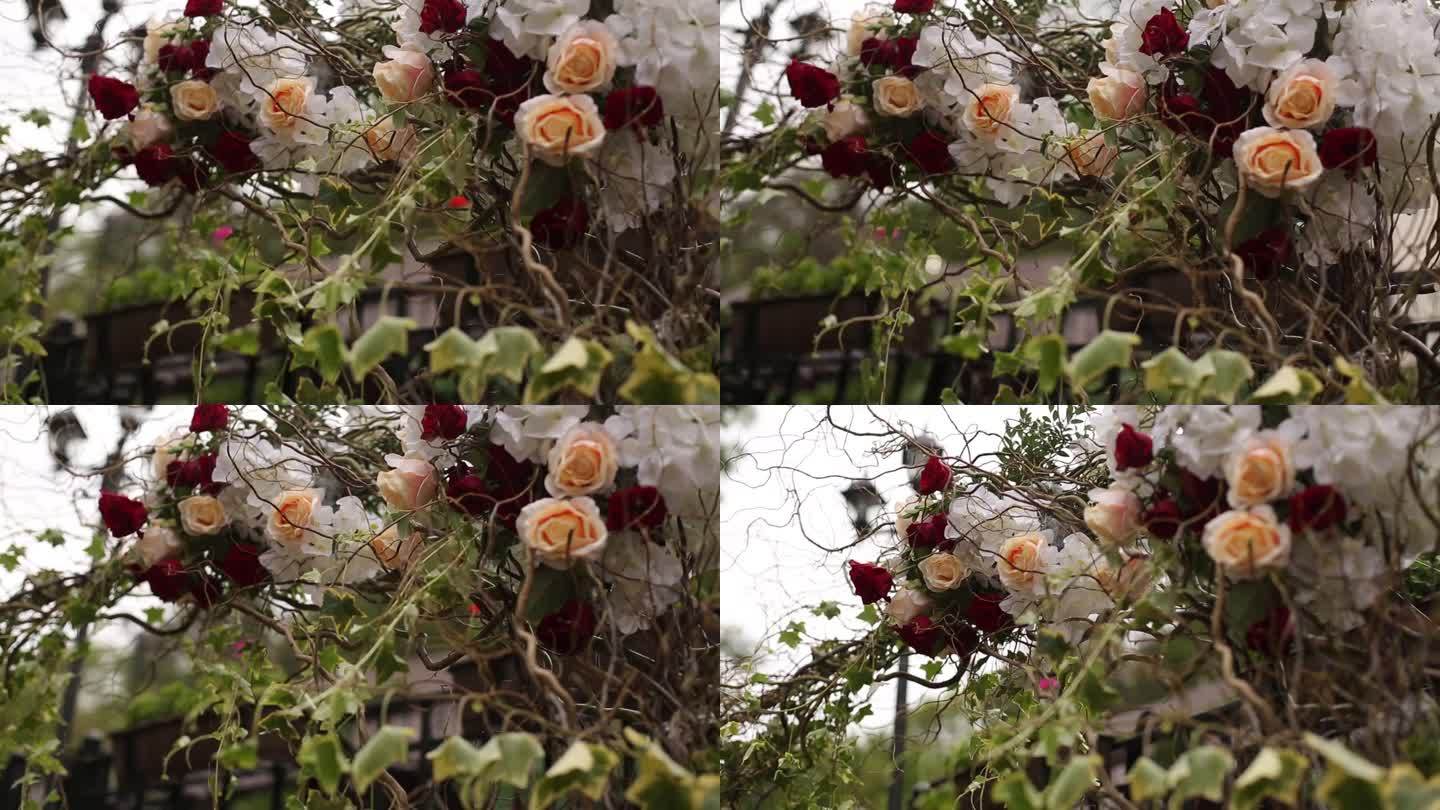优雅的婚礼拱门装饰着红、白玫瑰。户外婚礼装饰，插花特写，花园婚礼设置。新娘牌坊鲜花，浪漫场地细节，活