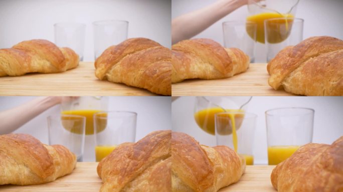 早餐的时刻。给家人的新鲜羊角面包和橙汁。黄油羊角面包。