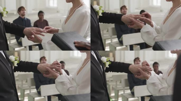 教堂婚礼上，新娘把戒指戴在新郎手指上