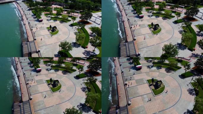 位于市中心的威海幸福公园鸟瞰图，人们在海边的钢琴师雕塑附近打砸抢