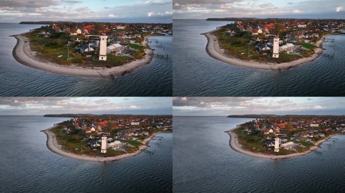 Strib Odde的航拍镜头，在小带入口处的历史灯塔的美丽景色，相机的撤退运动。丹麦富南海岸的米德