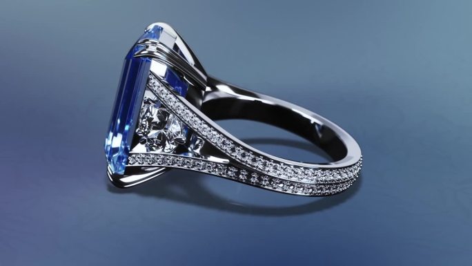 白色的金戒指镶着蓝色的宝石和钻石