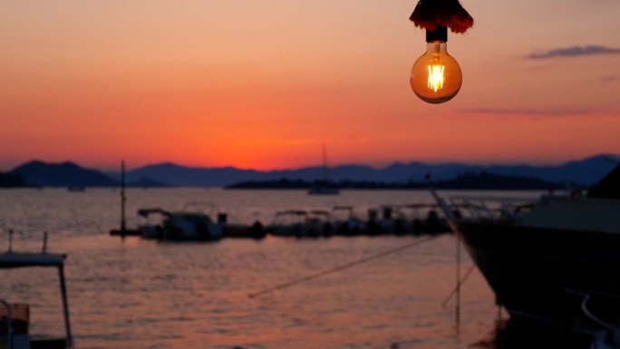 海上落日背景上的一盏电灯