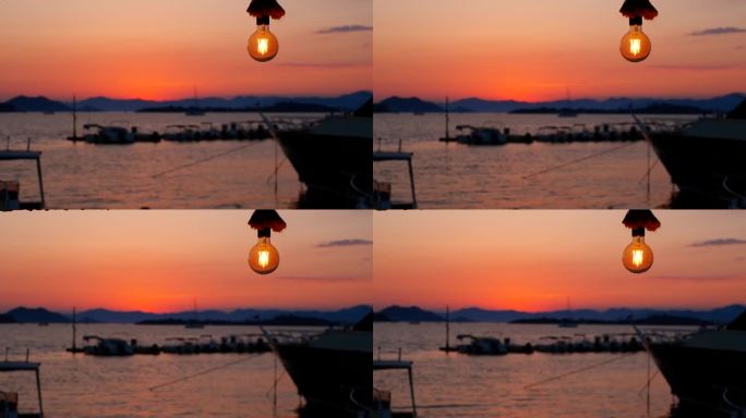 海上落日背景上的一盏电灯