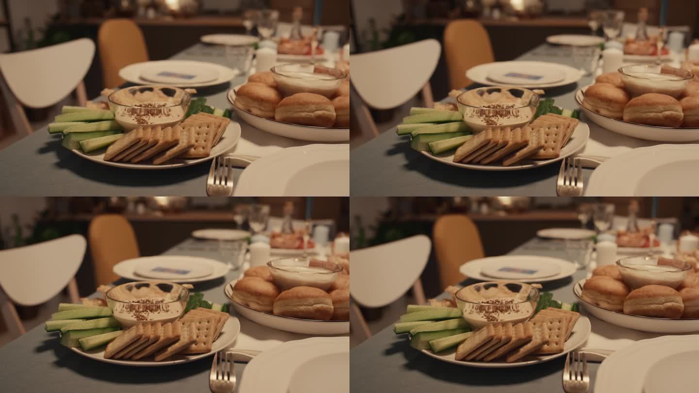 犹太家庭光明节晚餐上的鹰嘴豆泥和苏加尼尤特