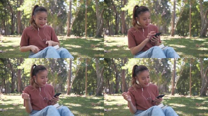 一位年轻女子坐在公园里用手机，戴着耳机听音乐。