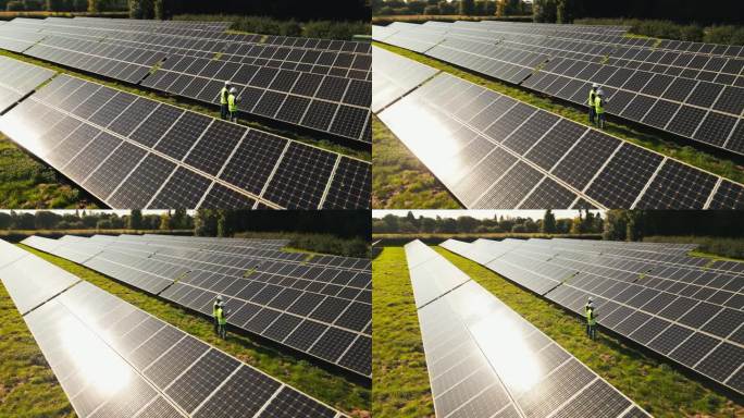 无人机拍摄的工程师在现场检查太阳能电池板产生可再生能源