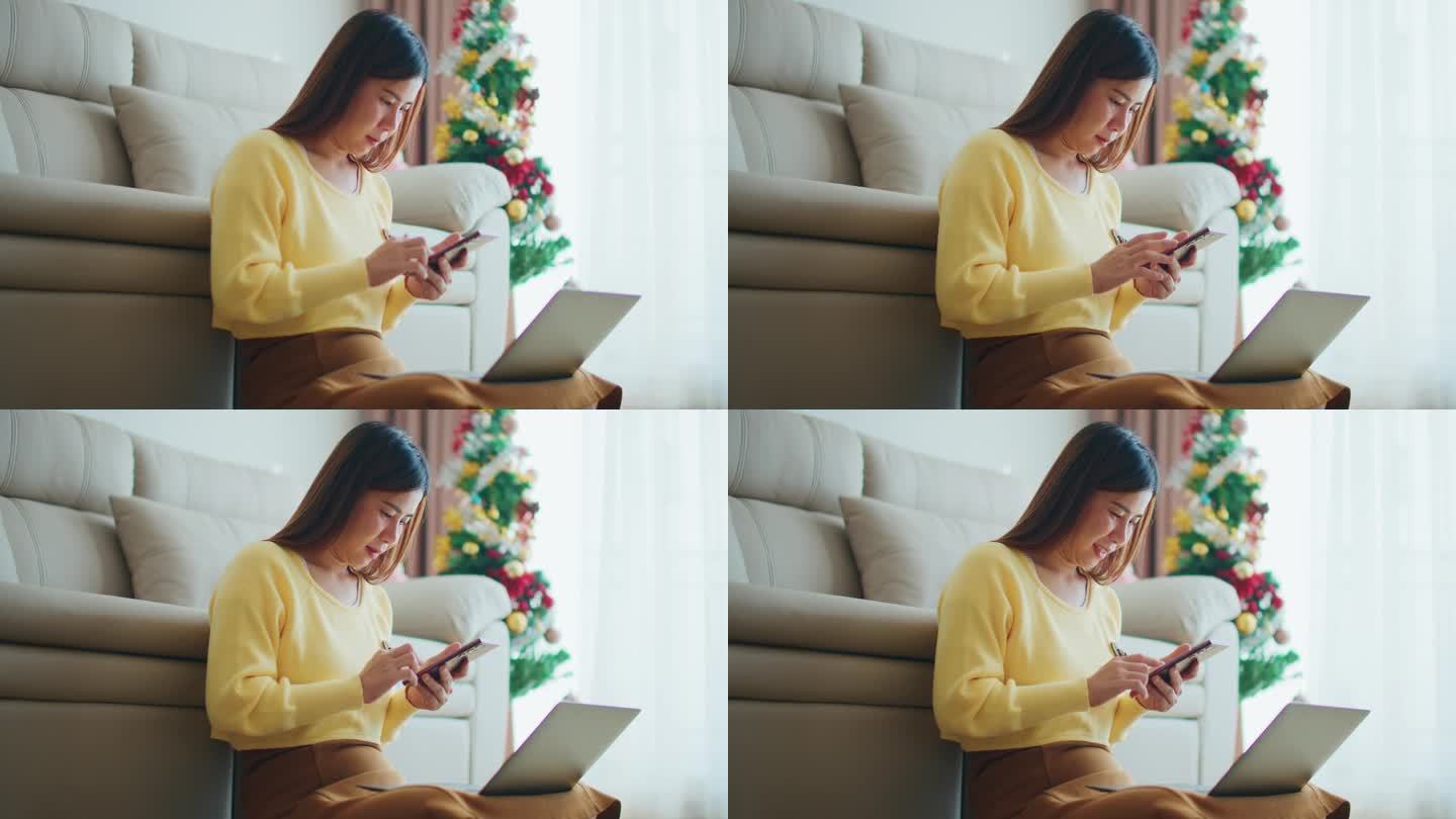 女性在圣诞节使用智能手机的手。