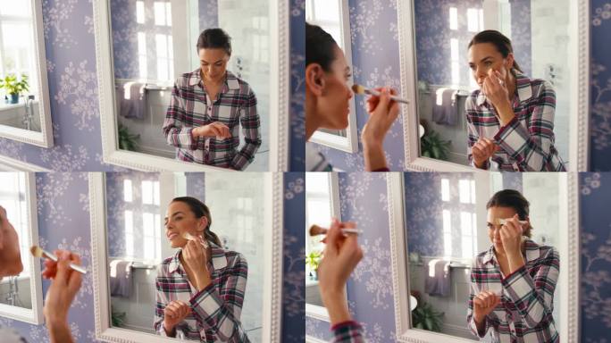 在家的女人对着浴室的镜子化妆