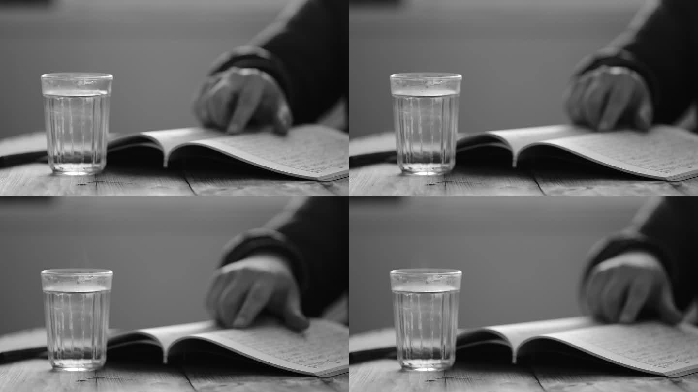 一杯热水和正在看书的人手部动作