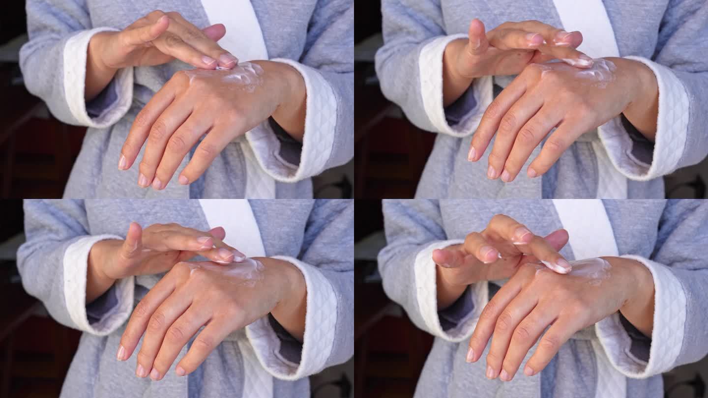 护肤美容产品女士在她的手上涂抹保湿霜