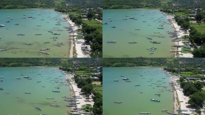 在一个炎热的夏日午后，印度尼西亚龙目岛的海岸上，清澈的海水和多艘船只。天线。