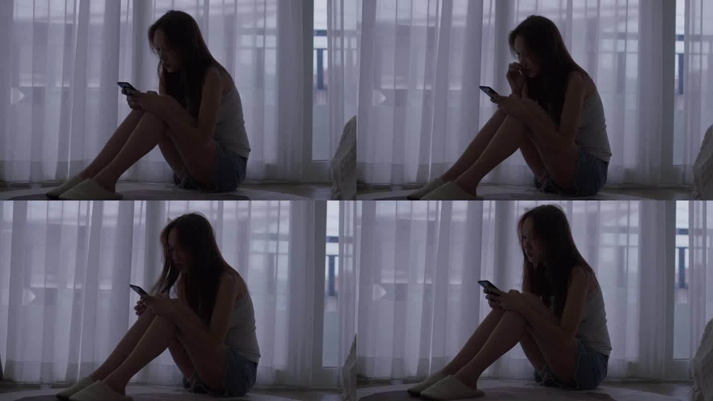 忧郁的年轻亚洲女子独自坐在家里的剪影