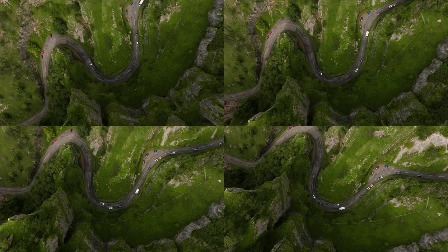 电影鸟瞰图汽车行驶在切达峡谷路的蛇形曲线在常绿的自然景观