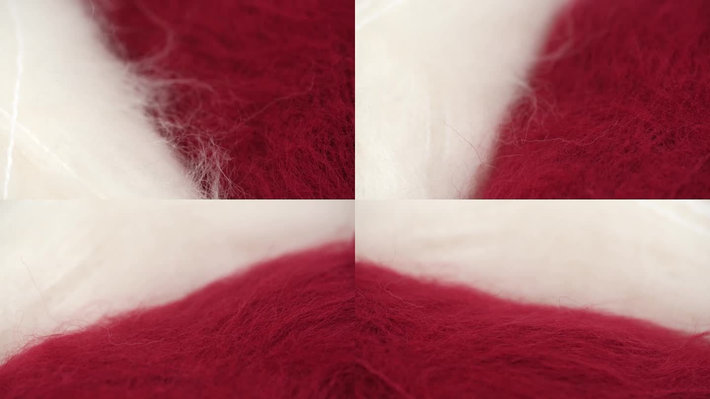 毛绒绒的红色和白色天然羊毛特写，用于编织和钩针编织，旋转。宏。