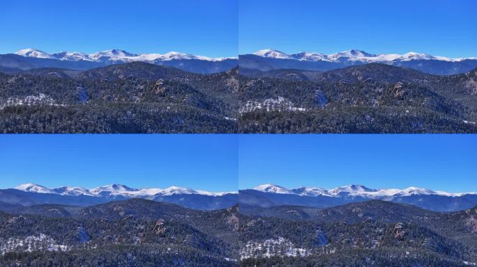 圣诞第一场雪常绿三姐妹前Range丹佛山蓝天埃文斯航拍电影无人机清脆寒冷的早晨美丽的蓝天霜松树向上运