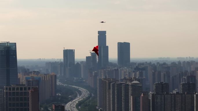 航拍无人机悬挂五星红旗飘扬在西安城市上空