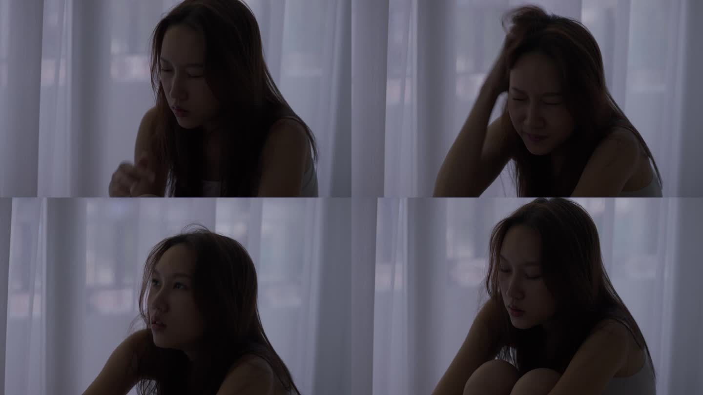 忧郁的年轻亚洲女子独自坐在家里的剪影