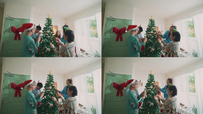 朋友一起在圣诞树上装饰，手持拍摄