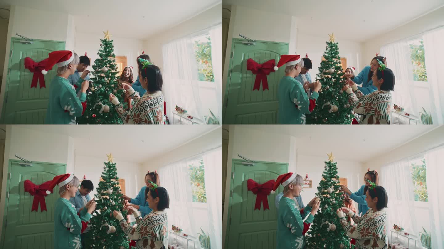 朋友一起在圣诞树上装饰，手持拍摄